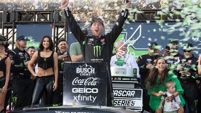 Tyler Reddick, center, celebrates after winning a NASCAR Cup Series auto race at Circuit of...