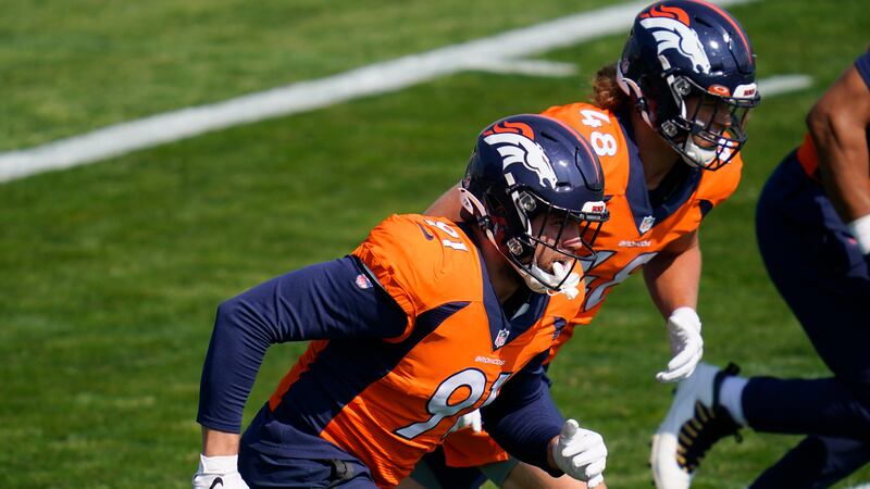 Denver Broncos linebackers Anthony Chickillo, front, and Derrek Tuszka take part in drills...