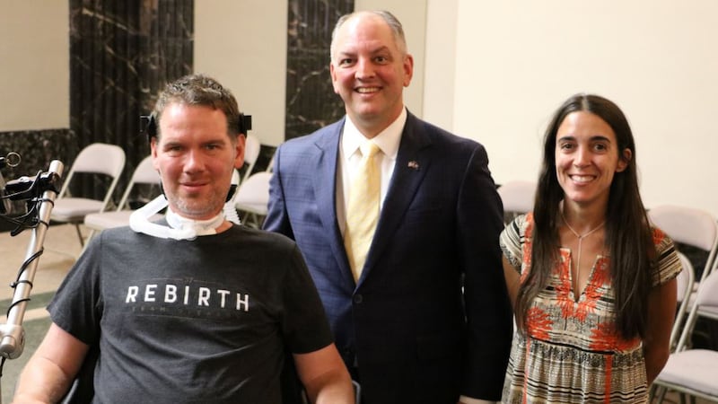 Louisiana Governor John Bel Edwards (center) poses for a photo with former New Orleans Saints...