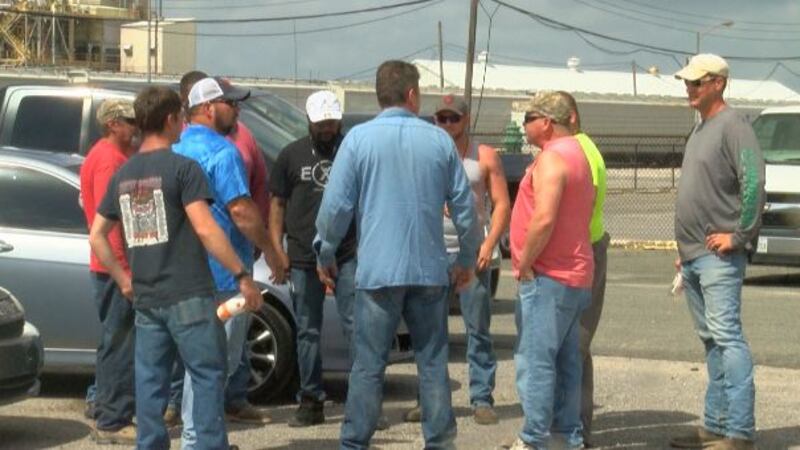 Workers wait in parking lot near Juniper, hoping to get back personal industrial tools they...