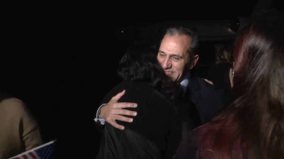 Emad Shargi hugs someone upon arrival in the U.S. at Fort Belvoir, Virginia, Tuesday morning.
