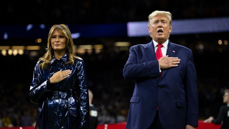 President Donald Trump and first lady Melania Trump stand for the national anthem before the...