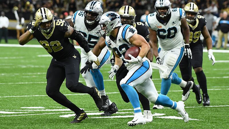 Saints defensive end Marcus Davenport pursues Panthers running back Christian McCaffrey