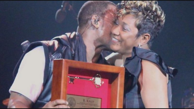 FILE - C. Denise Marcelle, then an EBR Metro Council member, gives R. Kelly a "key to the...