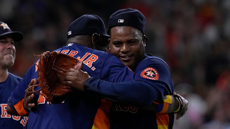 Houston Astros starting pitcher Framber Valdez, right, is congratulated by manager Dusty Baker...