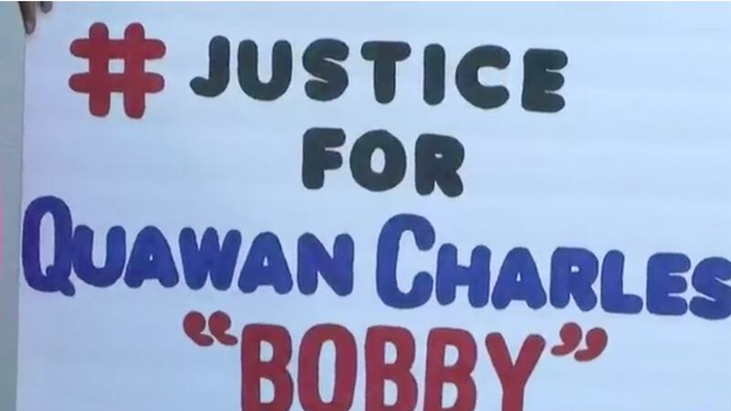 Demonstrators questioning the possibility that the death of Quawan Charles involves foul play...